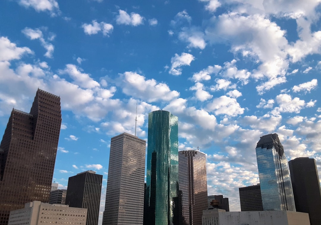a view of a city with skyscrapers and clouds in the sky